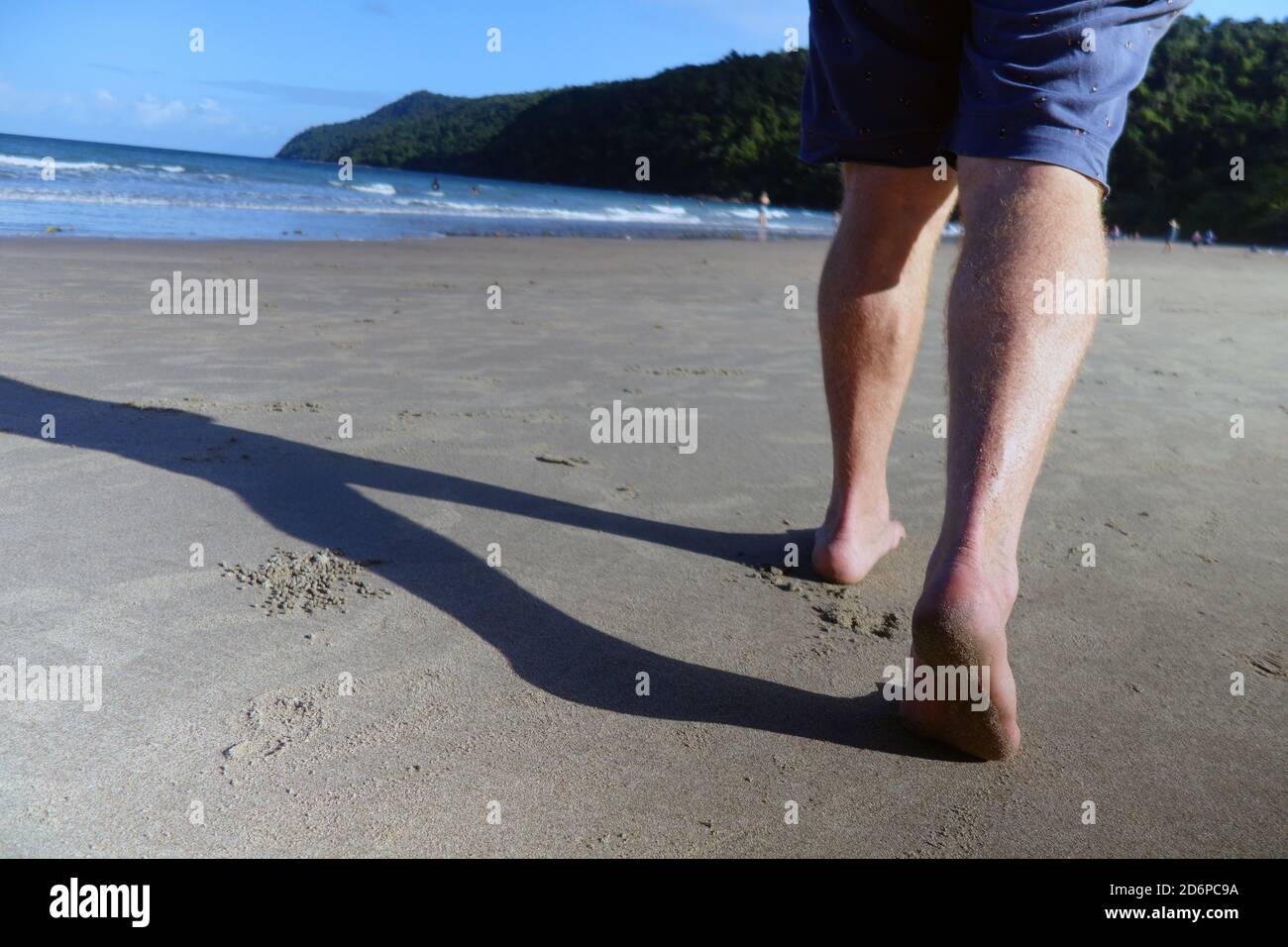 Man walking on Etty Bay beach, near Innisfail, Queensland, Australia. No MR Stock Photo