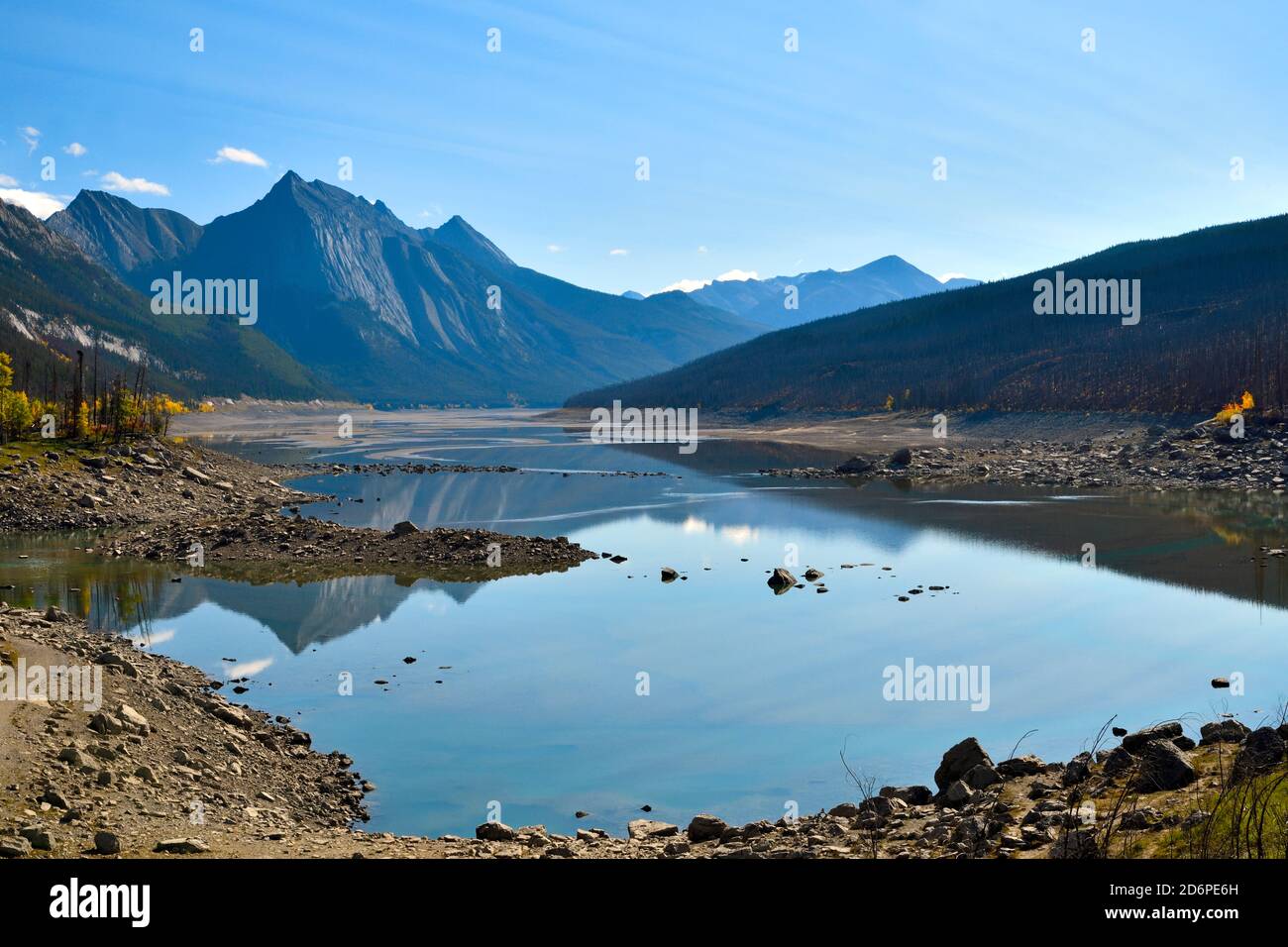 A landscape image of Medicine Lake on the Maligne lake road showing the low water in the lake with Annunciation Peak in the background in the famous J Stock Photo