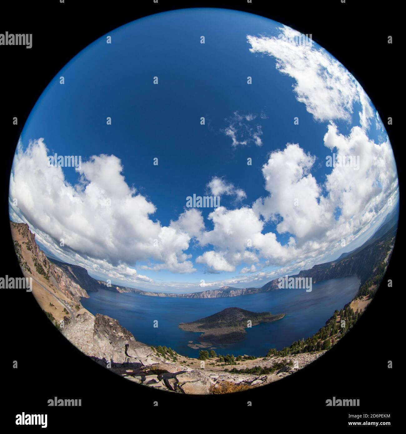 Crater Lake and sky distorted with a wide angle lens in to an abstract circle that gives a planetary effect. Stock Photo