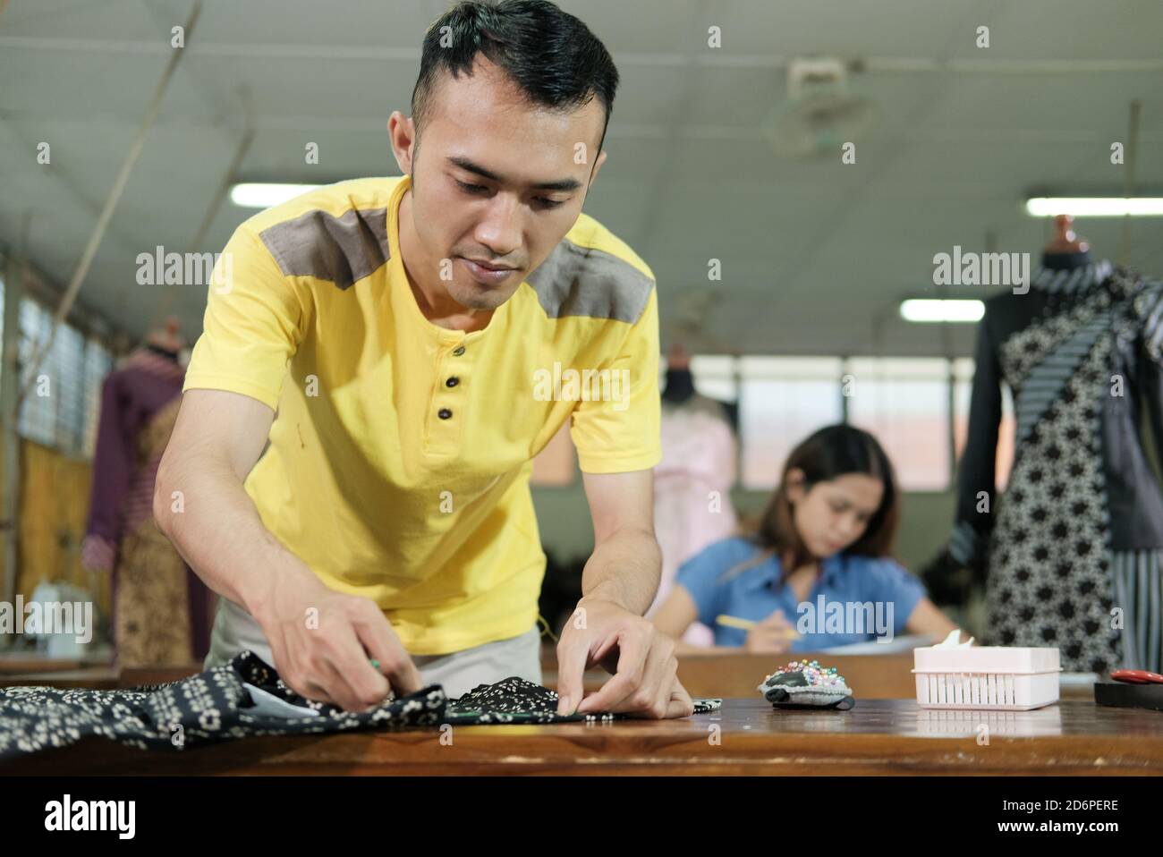 Den Make Ruler the seamstress carefully measures the clothes with a ruler in the den ...