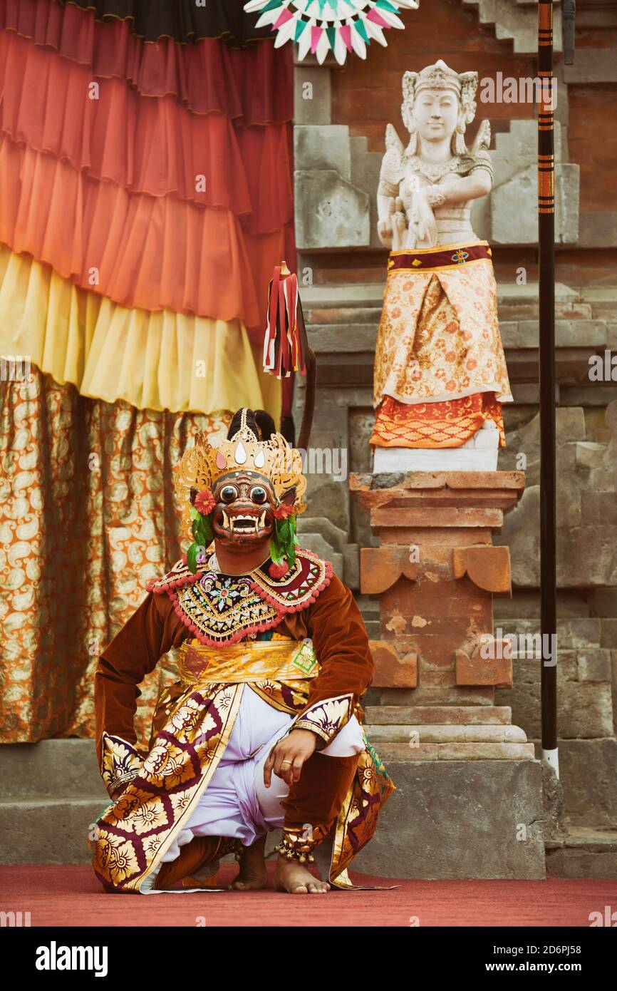 Traditional Balinese costume and mask Tari Wayang Topeng - characters of Bali culture. Temple ritual dance at ceremony on religious holiday. Stock Photo