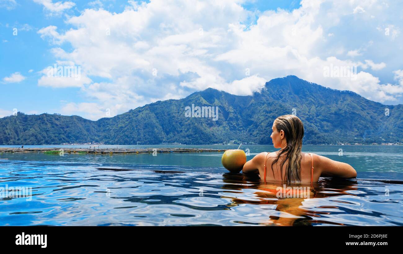 Young woman relax in infinity pool with lake view. Natural hot spring spa  under Batur volcano. Travel in Kintamani, Bali. Healthy lifestyle Stock  Photo - Alamy