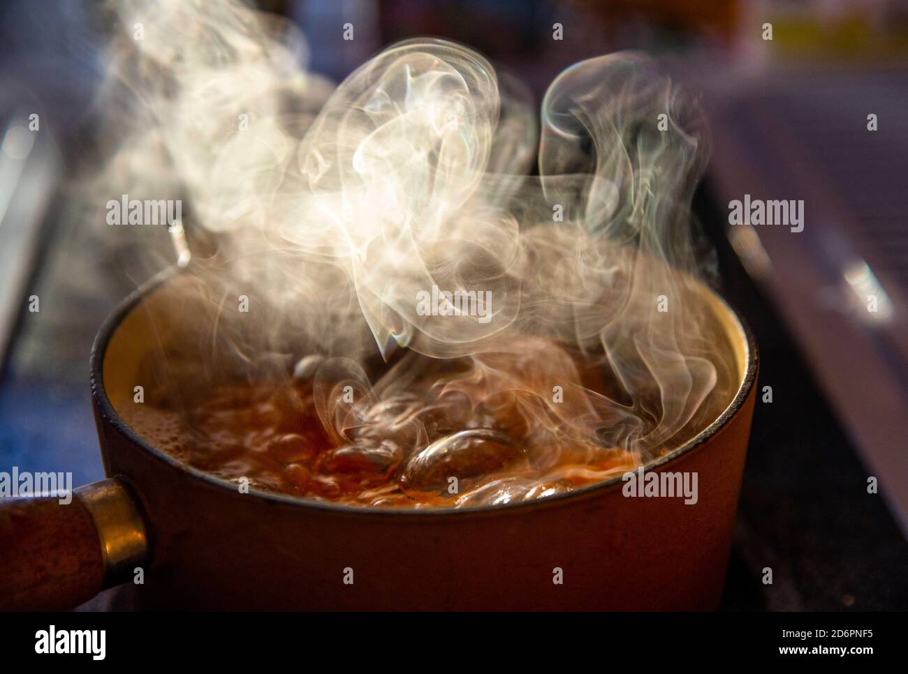 eggs boiling on the stove with steam rising Stock Photo