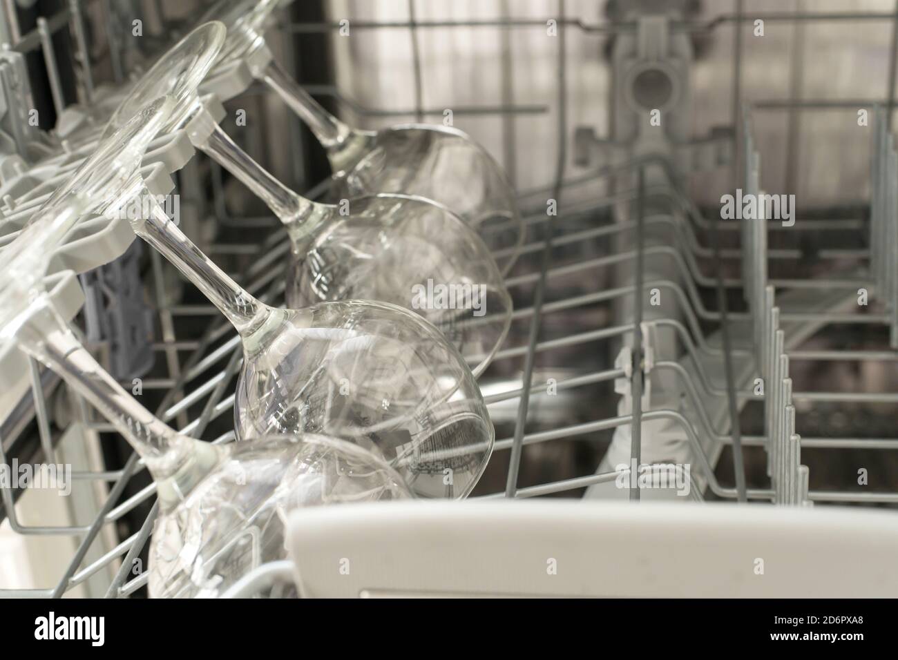 glasses of wine are stacked rhythmically in the dishwasher Stock Photo