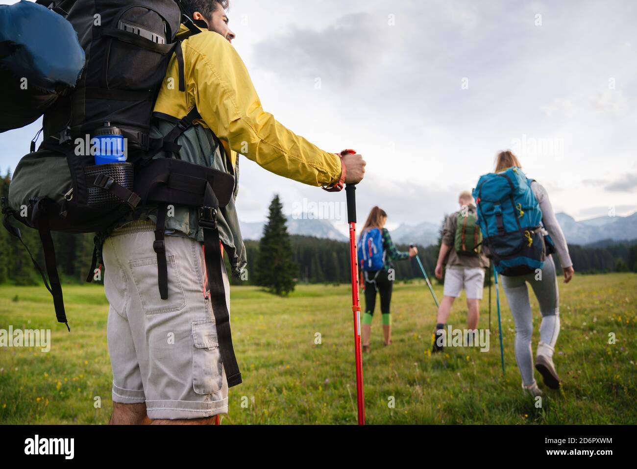 Group of happy friends with backpacks hiking together Stock Photo - Alamy