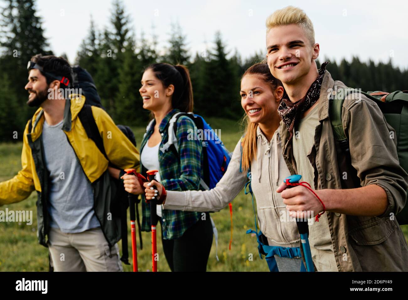 Group of happy friends with backpacks hiking together Stock Photo - Alamy