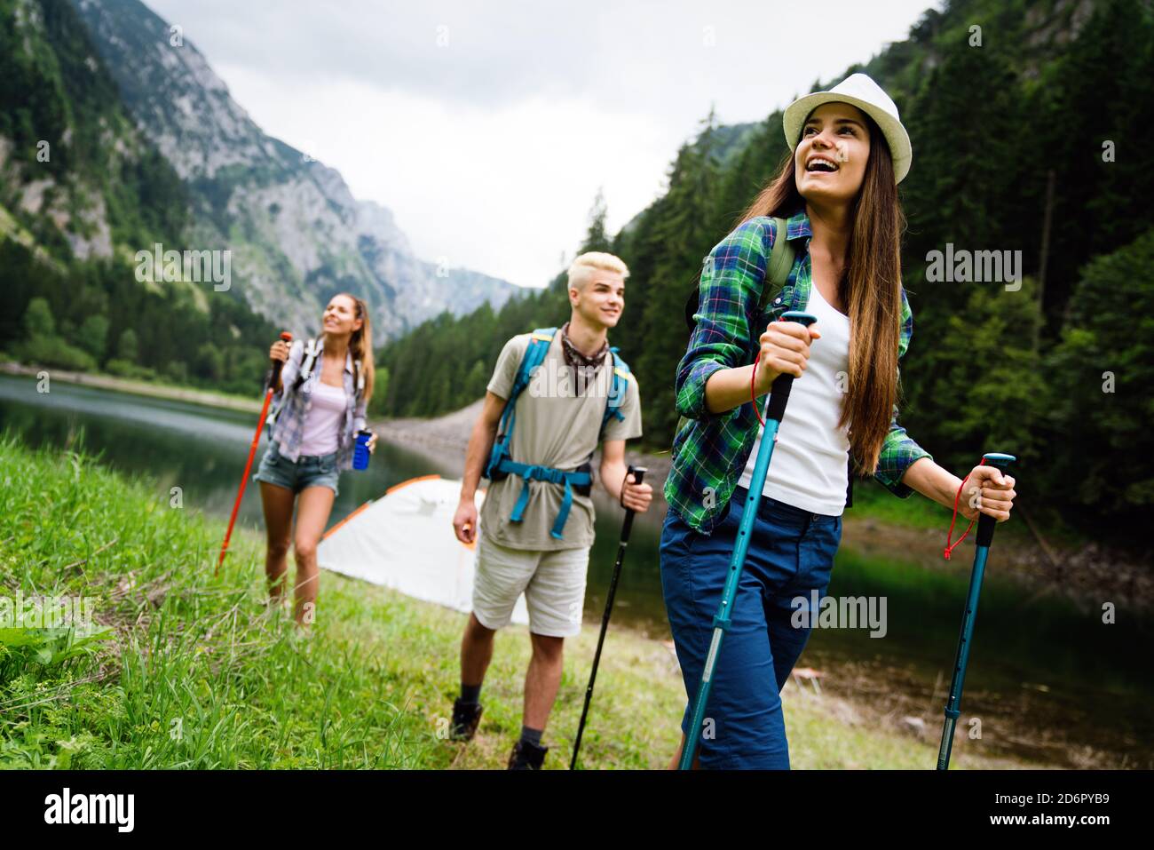 Hiking with friends is so fun. Group of young people with backpacks ...