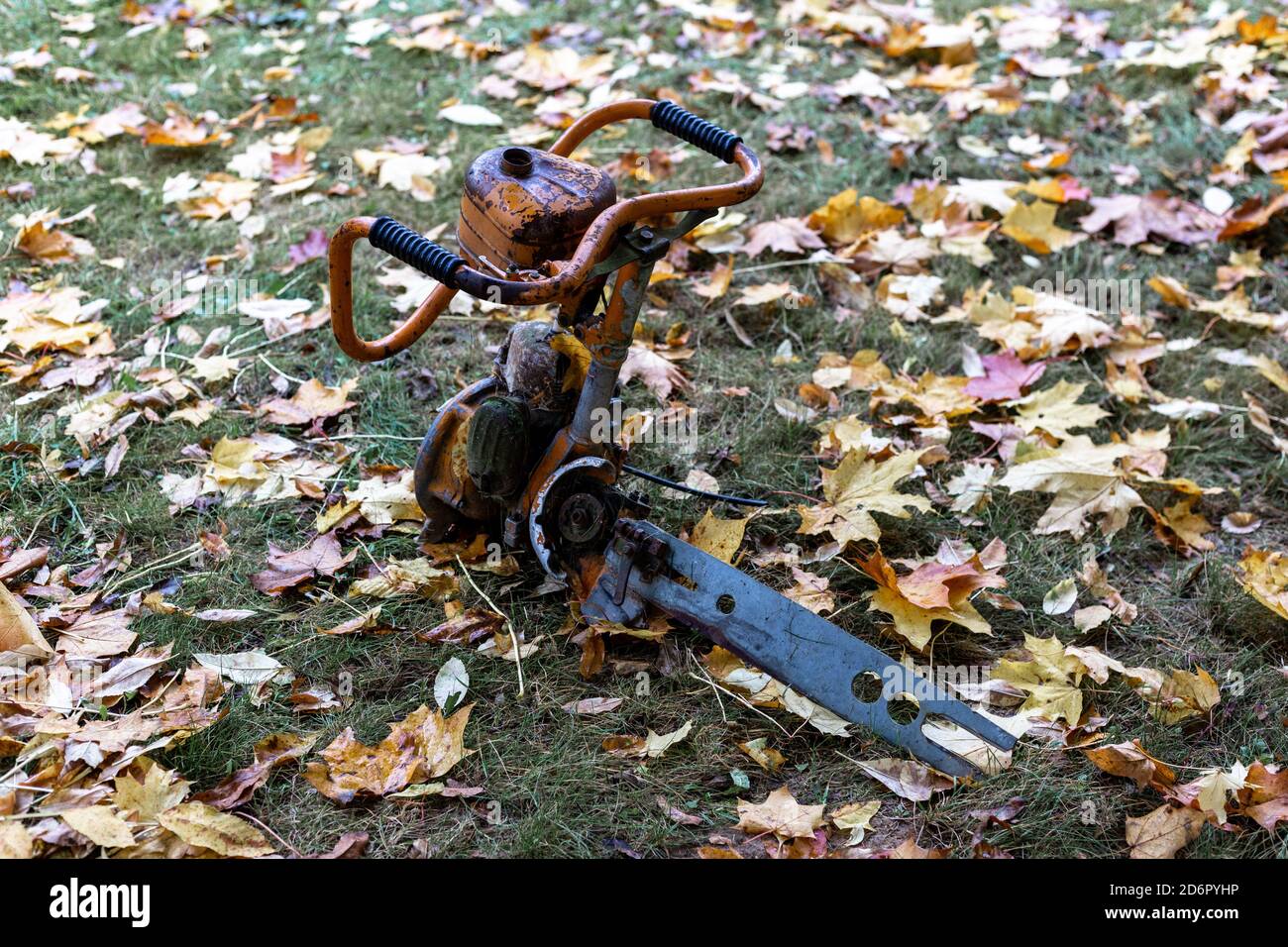 Broken chainsaw on the grass Stock Photo