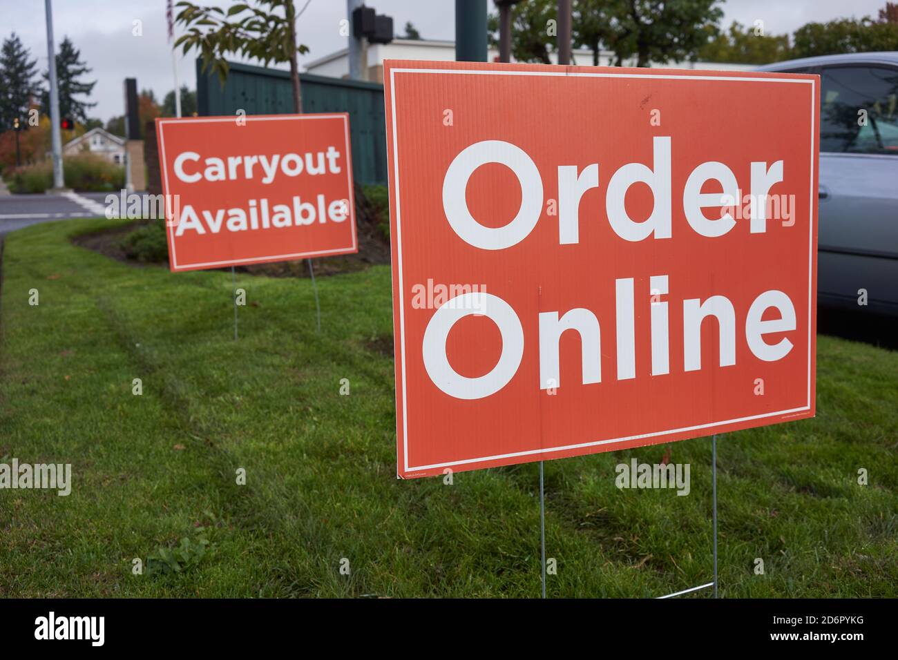 Order Online and Carryout Available signs outside a restaurant during the coronavirus pandemic. Stock Photo