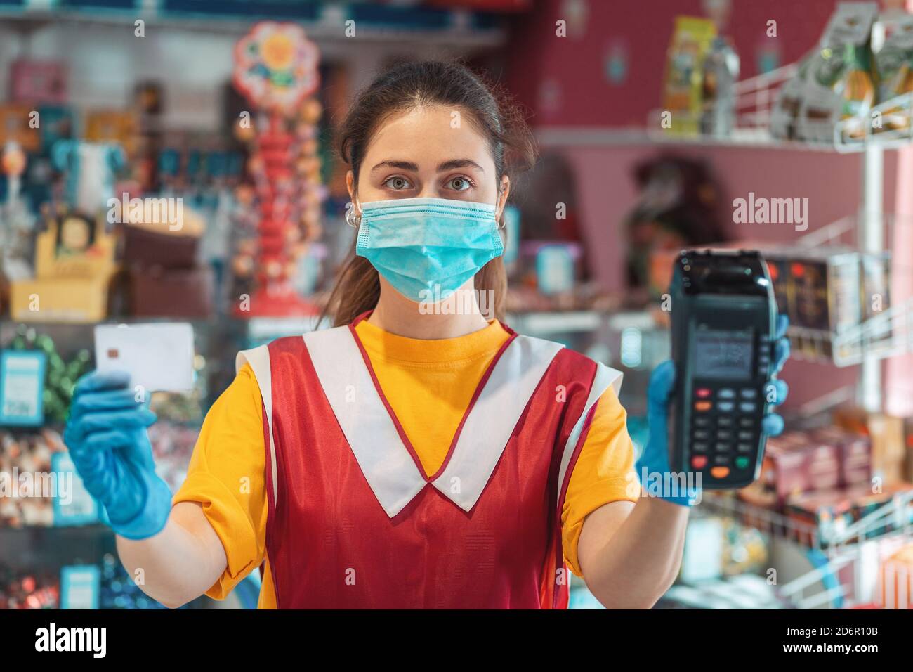 Portrait of an female employee in uniform with a medical mask and ...
