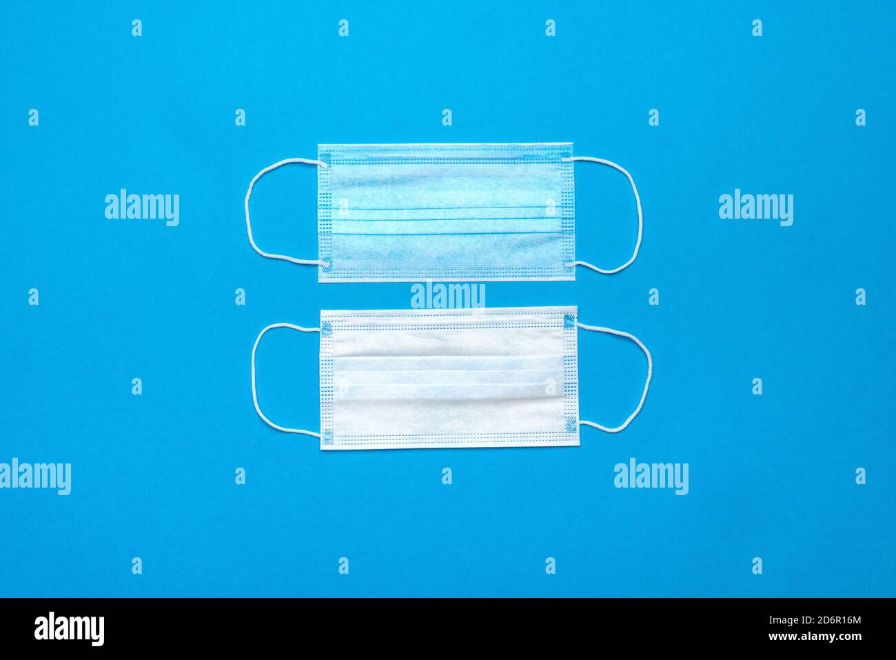 Disposable blue medical face masks on blue background Stock Photo - Alamy