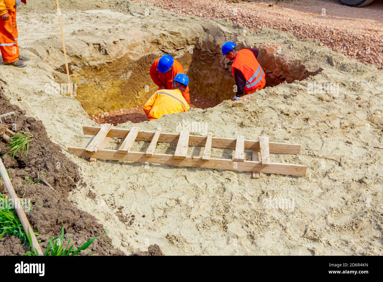 Workers are using shovels to set up level foundation to right measures