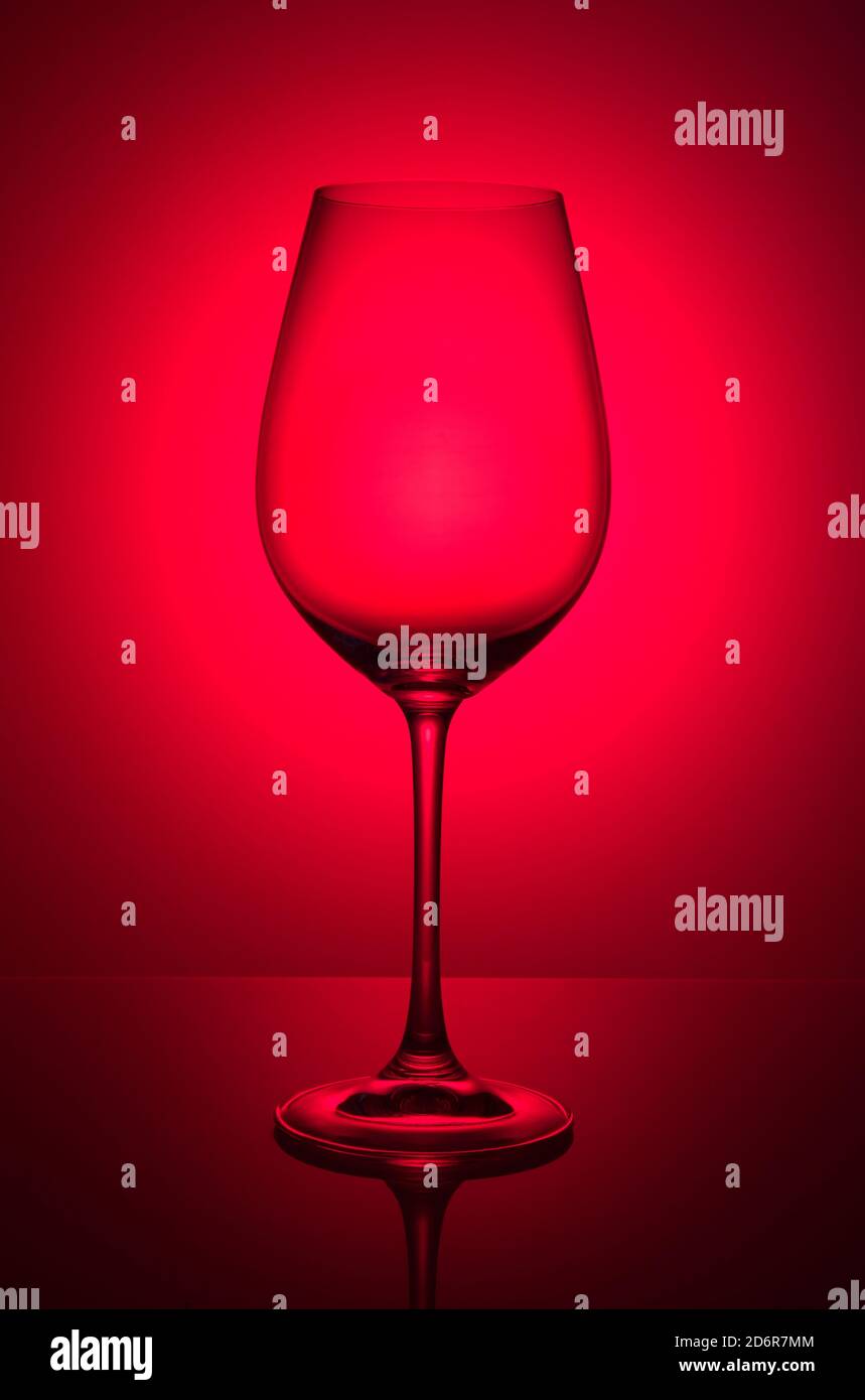 Wine glass on red color background, studio shooting Stock Photo - Alamy