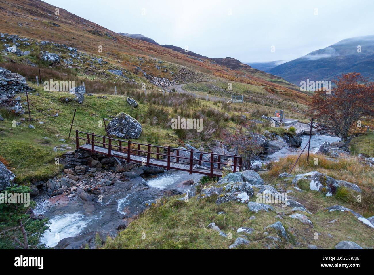 The rickety metal footbridge over the burn on the approach path to the mountain of Carn Gorm on glen Lyon, Perthshire, Scotland, UK Stock Photo