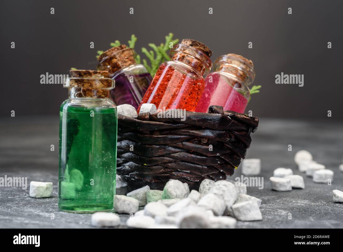 Shower gel in glass bottles and bath salt on a dark background. Spa