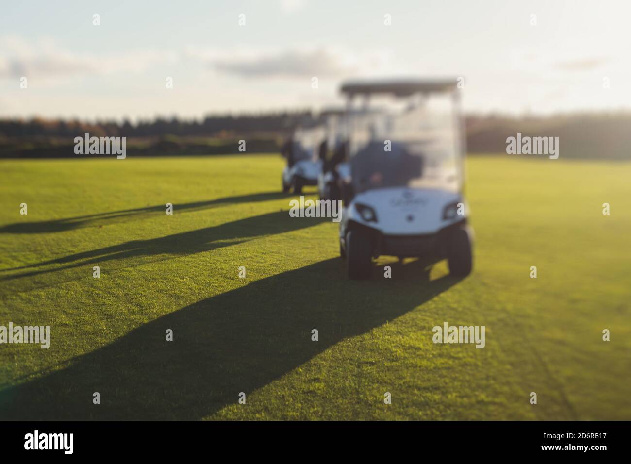 Golf electric cars riding on a golf course in the day, golf carts drive
