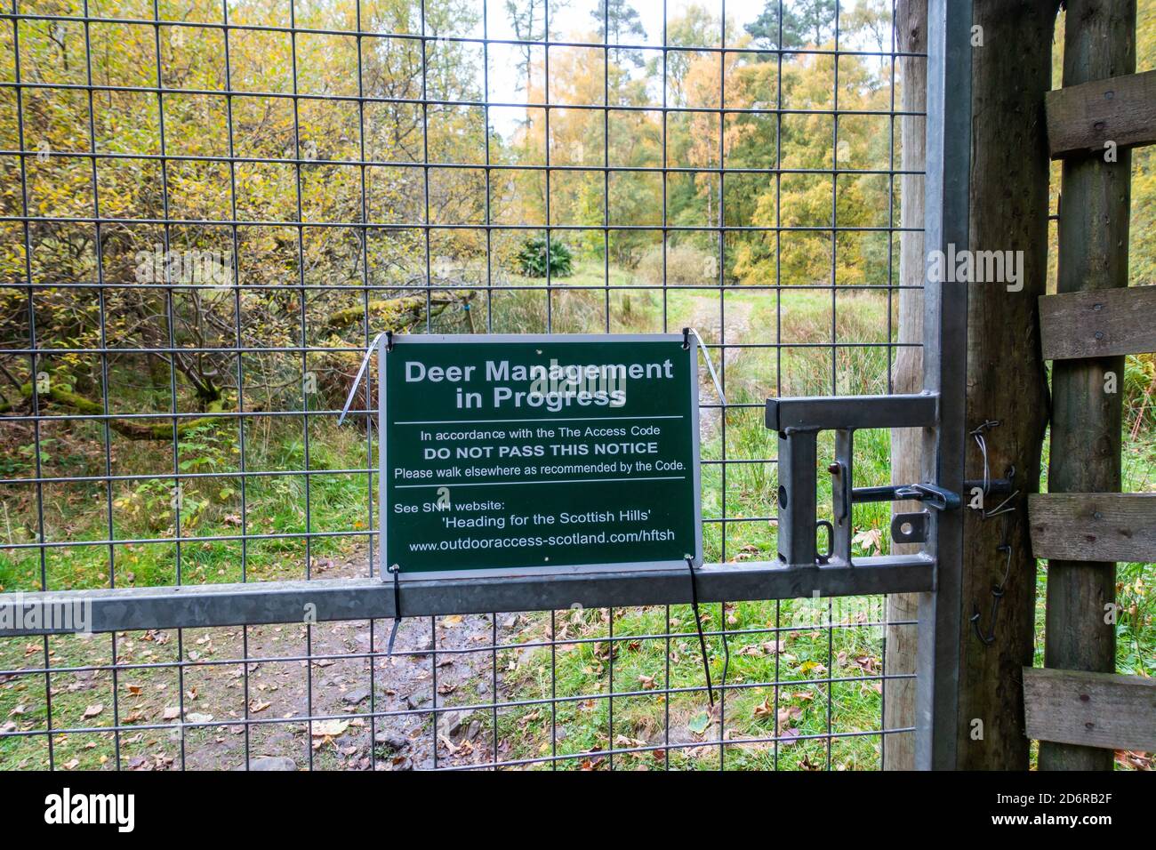 Sign saying Deer management in Progress on Scottish country estate gate. Stock Photo