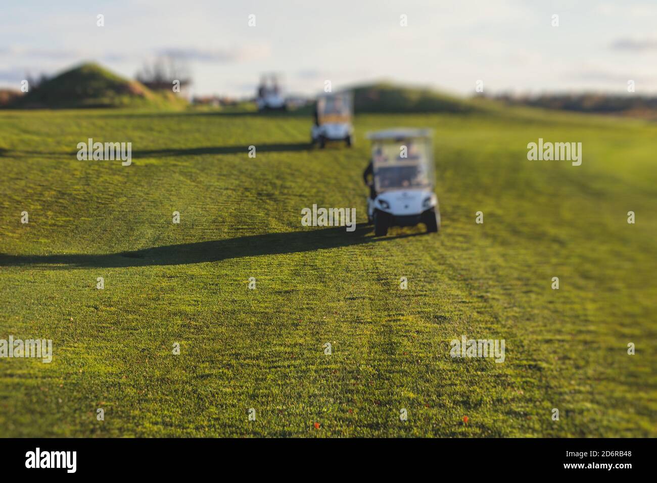 Golf electric cars riding on a golf course in the day, golf carts drive