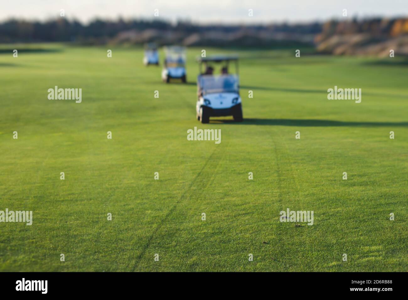 Golf electric cars riding on a golf course in the day, golf carts drive