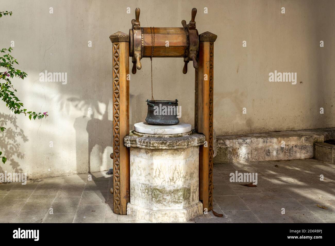 Old water well and copper bucket Stock Photo