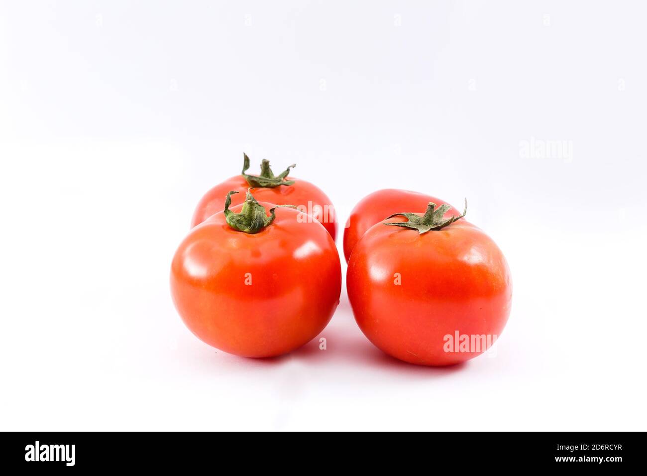 red ripe tomatoes isolated on white background Stock Photo - Alamy