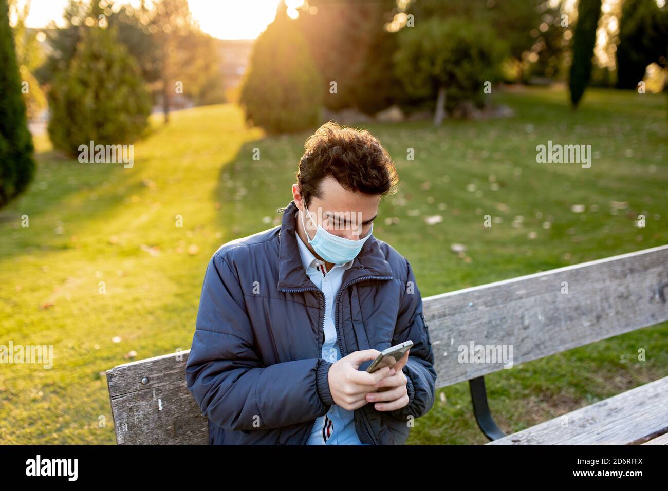 boy waiting on a bench Stock Photo - Alamy