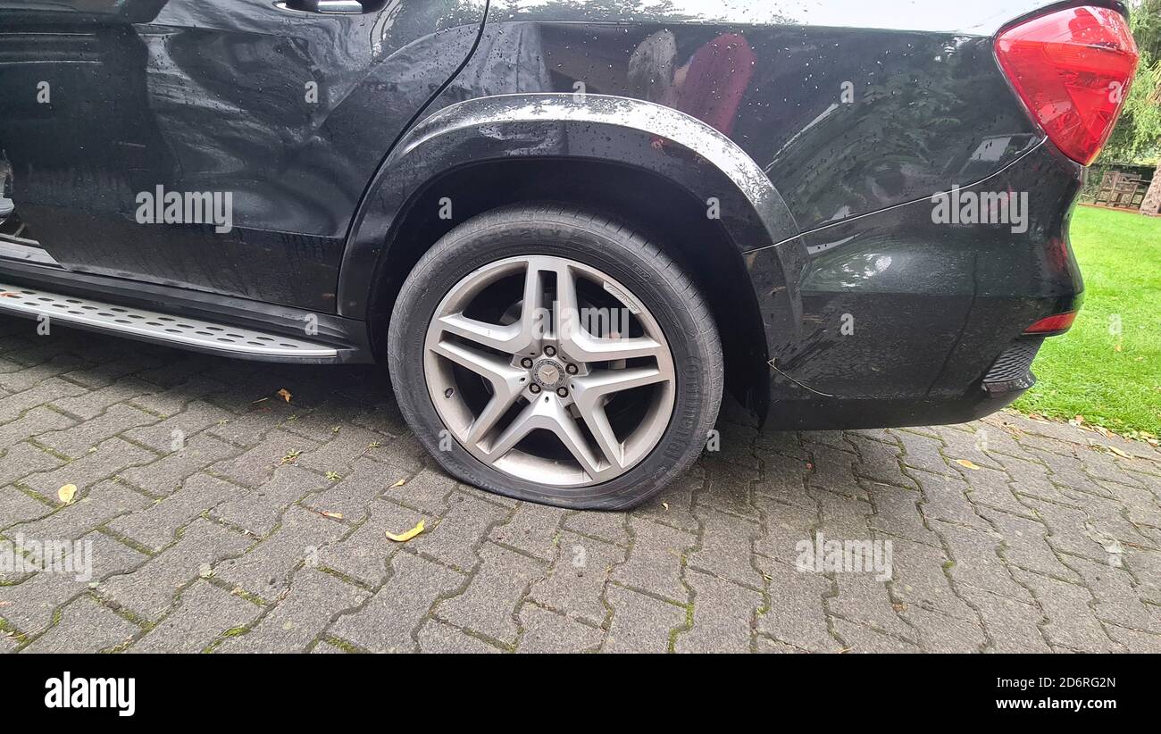 car with flat tire, Germany Stock Photo