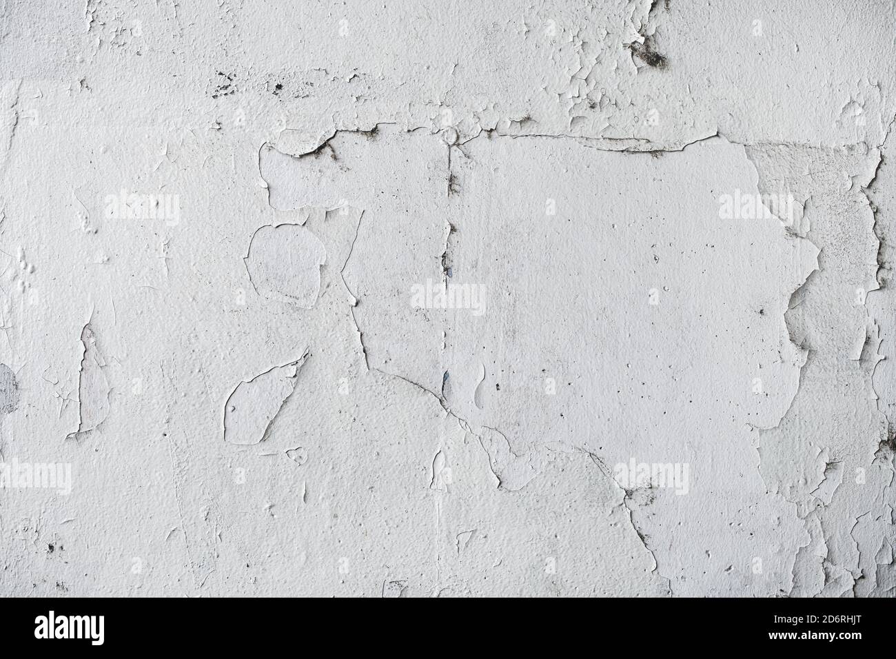 Grunge white texture of weathered wall with paint peeling off the surface, worn facade pattern as background Stock Photo