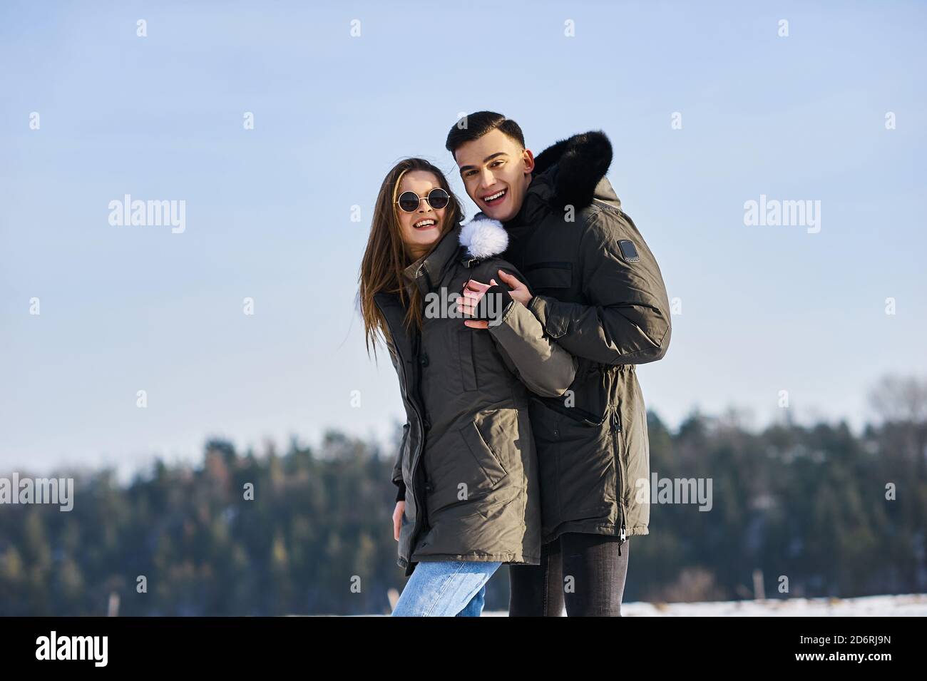 happy couple hugging and laughing outdoors in winter Stock Photo - Alamy