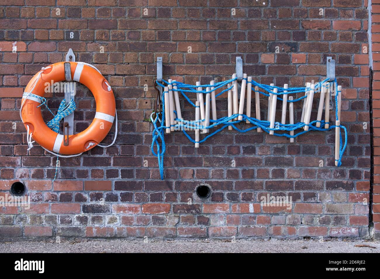 Orange and white lifebuoy with rope ladder in seacombe wirral july 2020 Stock Photo
