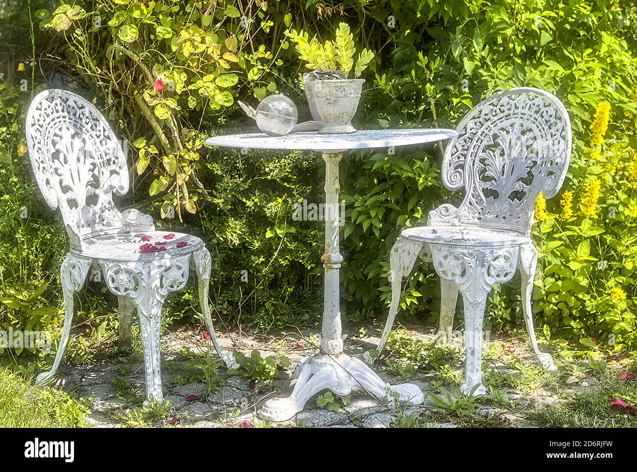 Vintage rusty wrought iron furniture in a garden Stock Photo - Alamy