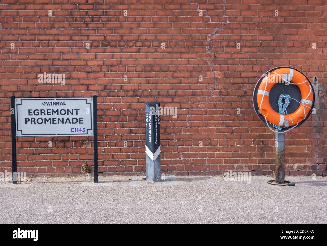 Street name mile marker and lifebuoy on the promenade in Wallasey Wirral July 2020 Stock Photo