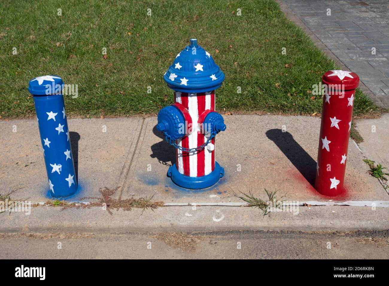 A fire hydrant and adjacent poles are decorated in a ptriotic motif. In Whitestone, Queens, New York City.a Stock Photo