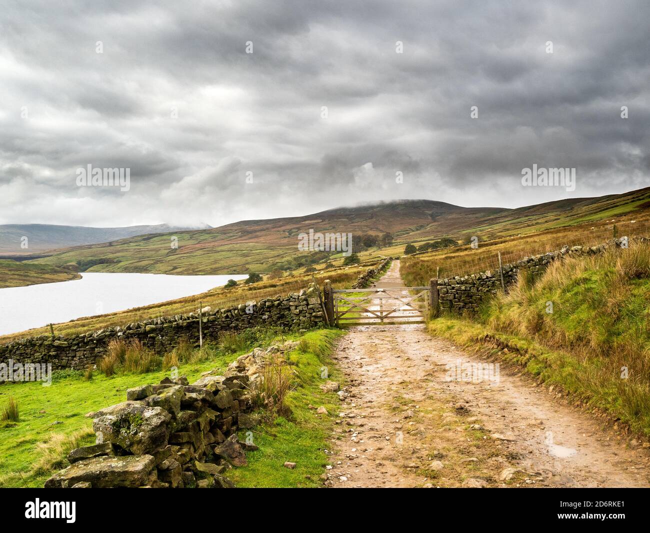 A track winds its way around the remote Scar House reservoir. Nidderdale. Yorkshire Dales Stock Photo