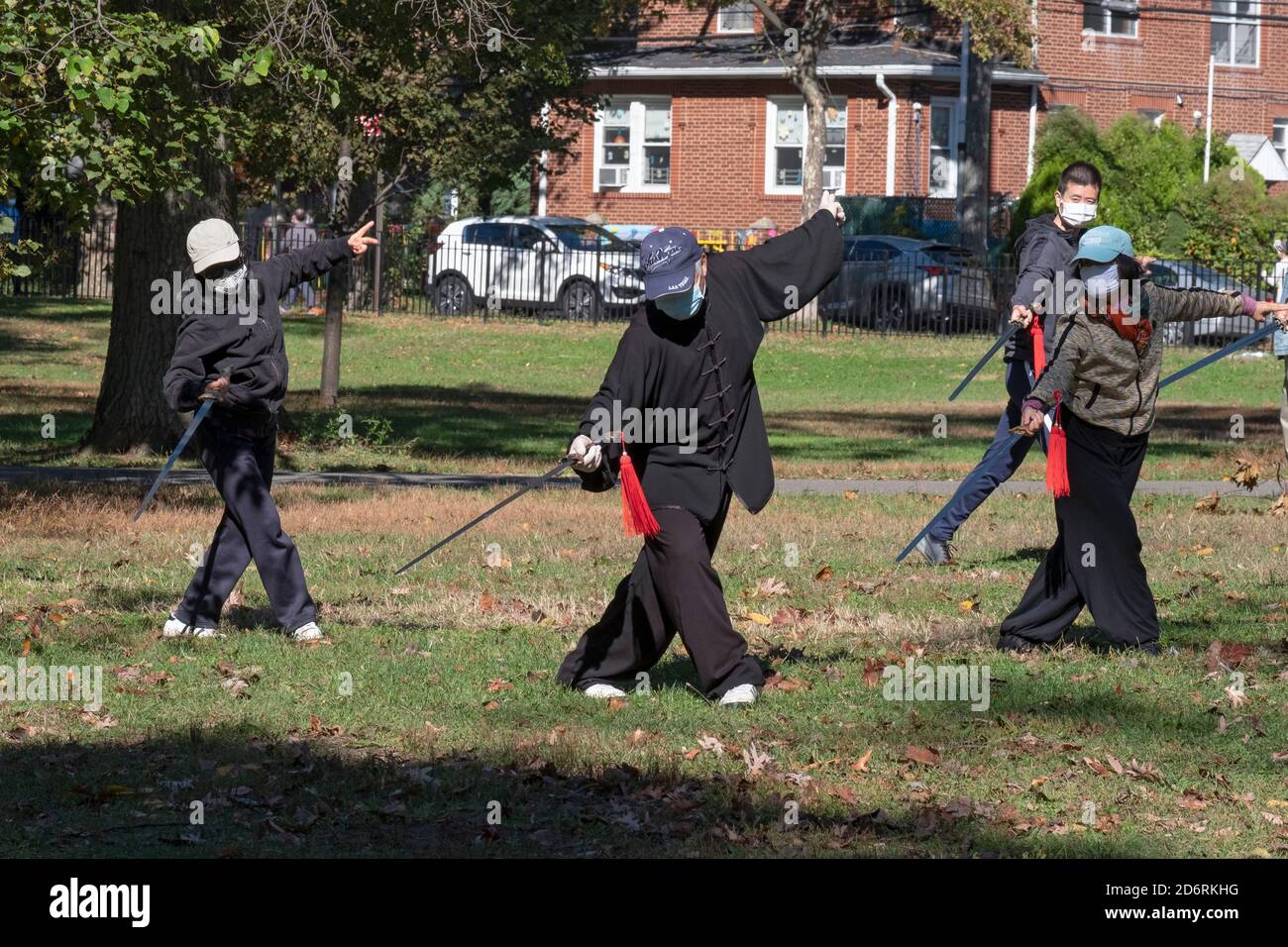 A Tai Chi class with swords in a park in Queens, New York. The