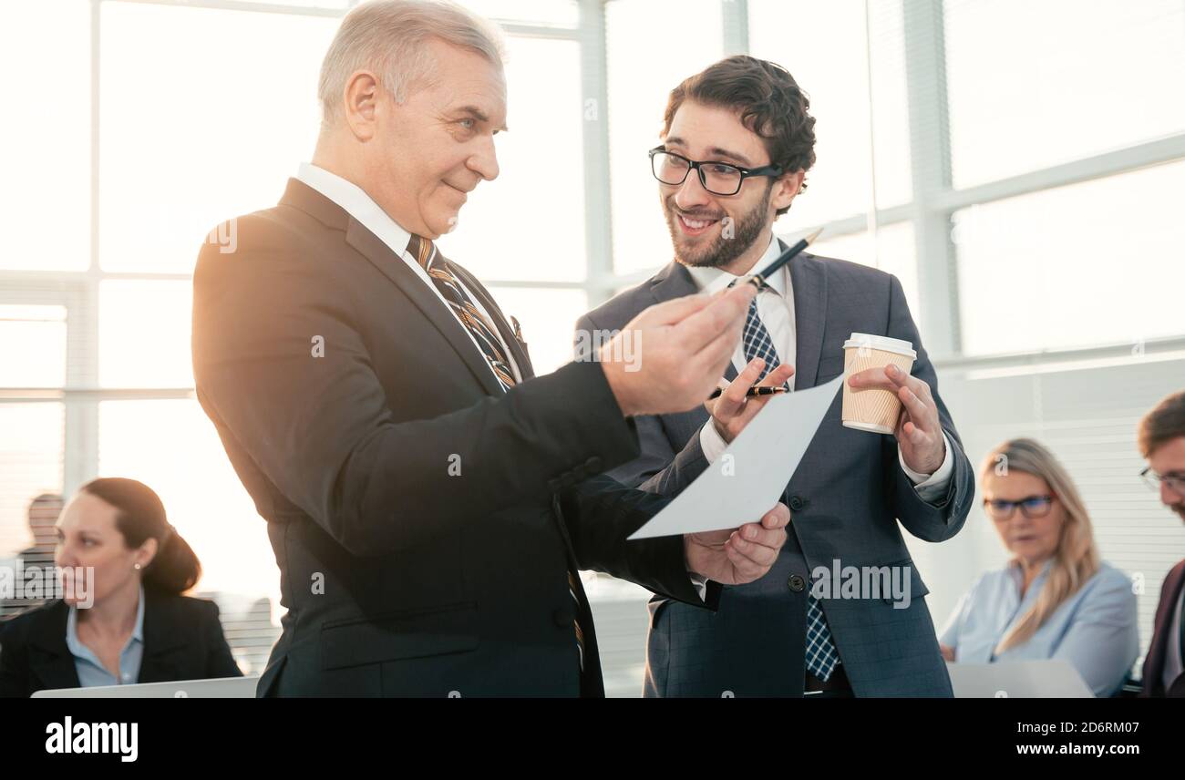 smiling business colleagues talking during a work break Stock Photo