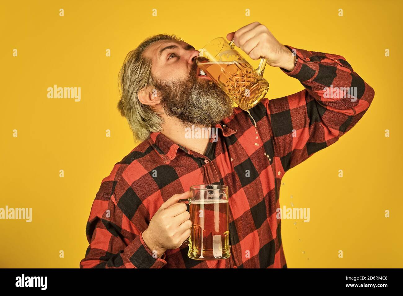 employ correct glassware. mature bearded barman hold beer glass