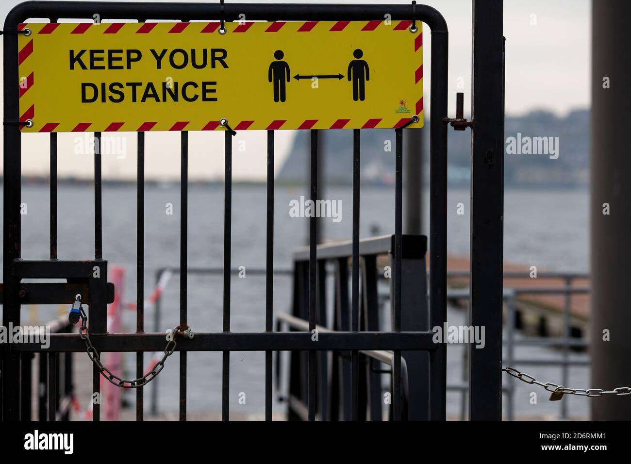 Cardiff, Wales, UK. 19th Oct, 2020. Coronavirus signage and padlocks on Cardiff Bay harbour gates as a national two-week ‘fire-break' lockdown to slow the spread of coronavirus in Wales is announced by First Minister of Wales Mark Drakeford, starting at 1800 on Friday 23rd October. Credit: Mark Hawkins/Alamy Live News Stock Photo