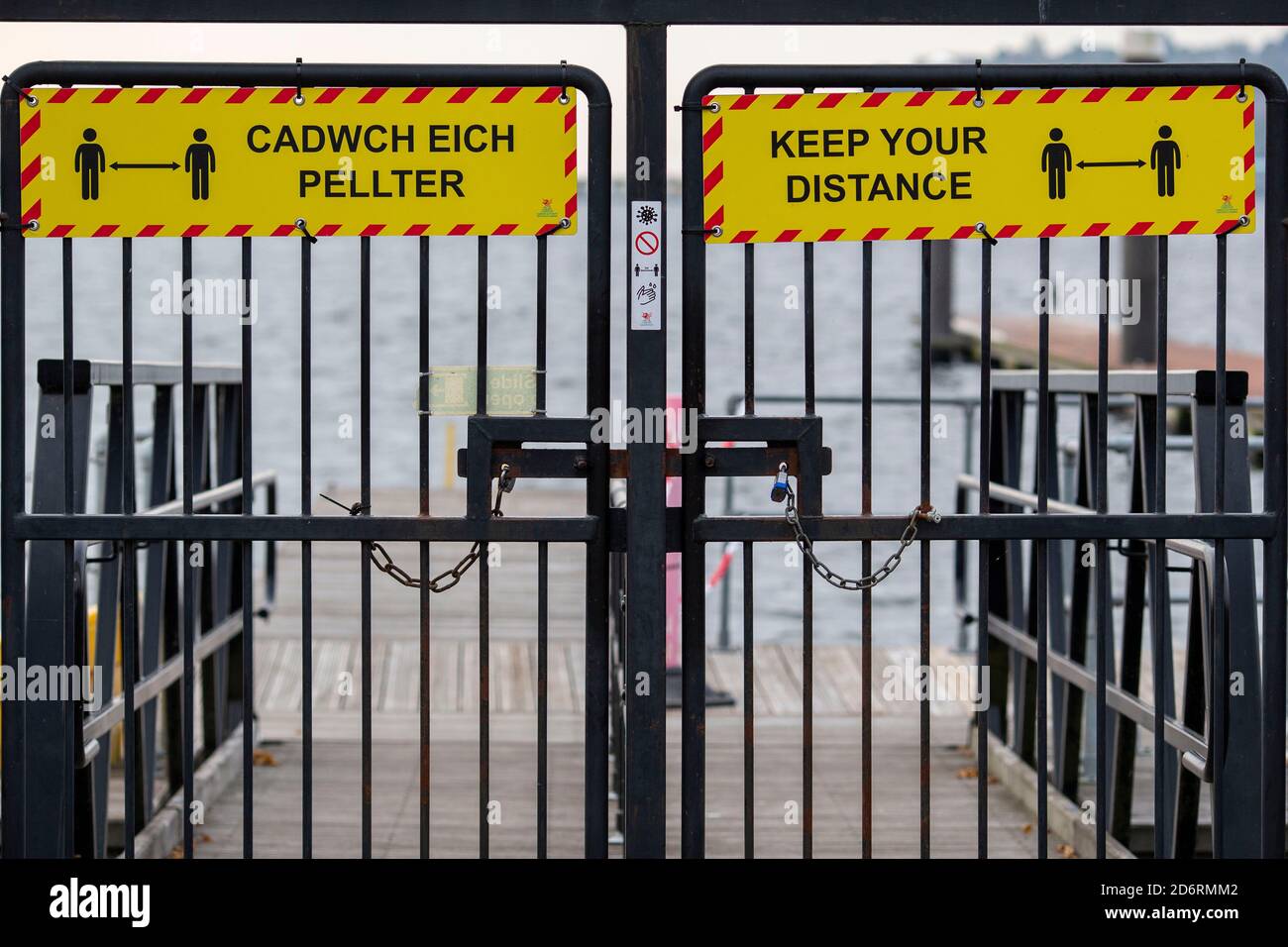 Cardiff, Wales, UK. 19th Oct, 2020. Coronavirus signage and padlocks on Cardiff Bay harbour gates as a national two-week ‘fire-break' lockdown to slow the spread of coronavirus in Wales is announced by First Minister of Wales Mark Drakeford, starting at 1800 on Friday 23rd October. Credit: Mark Hawkins/Alamy Live News Stock Photo