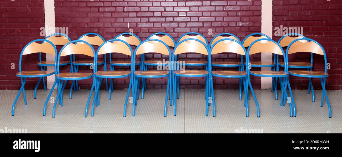 Two rows of college school chairs in a room before taking a class school photo Stock Photo