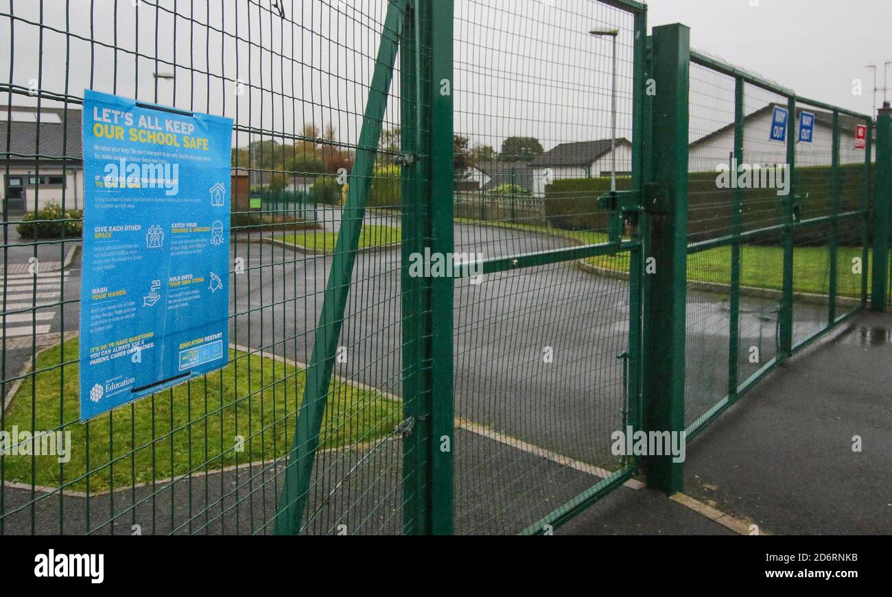 Magheralin, County Armagh, Northern Ireland, UK. 19 Oct 2020. Following restrictions announced by the Northern Ireland Executive last week, schools are now closed across Northern Ireland from today for the next two weeks. The closed gate of Maralin Village Primary School on a grey autumn day. Credit: CAZIMB/Alamy Live News. Stock Photo