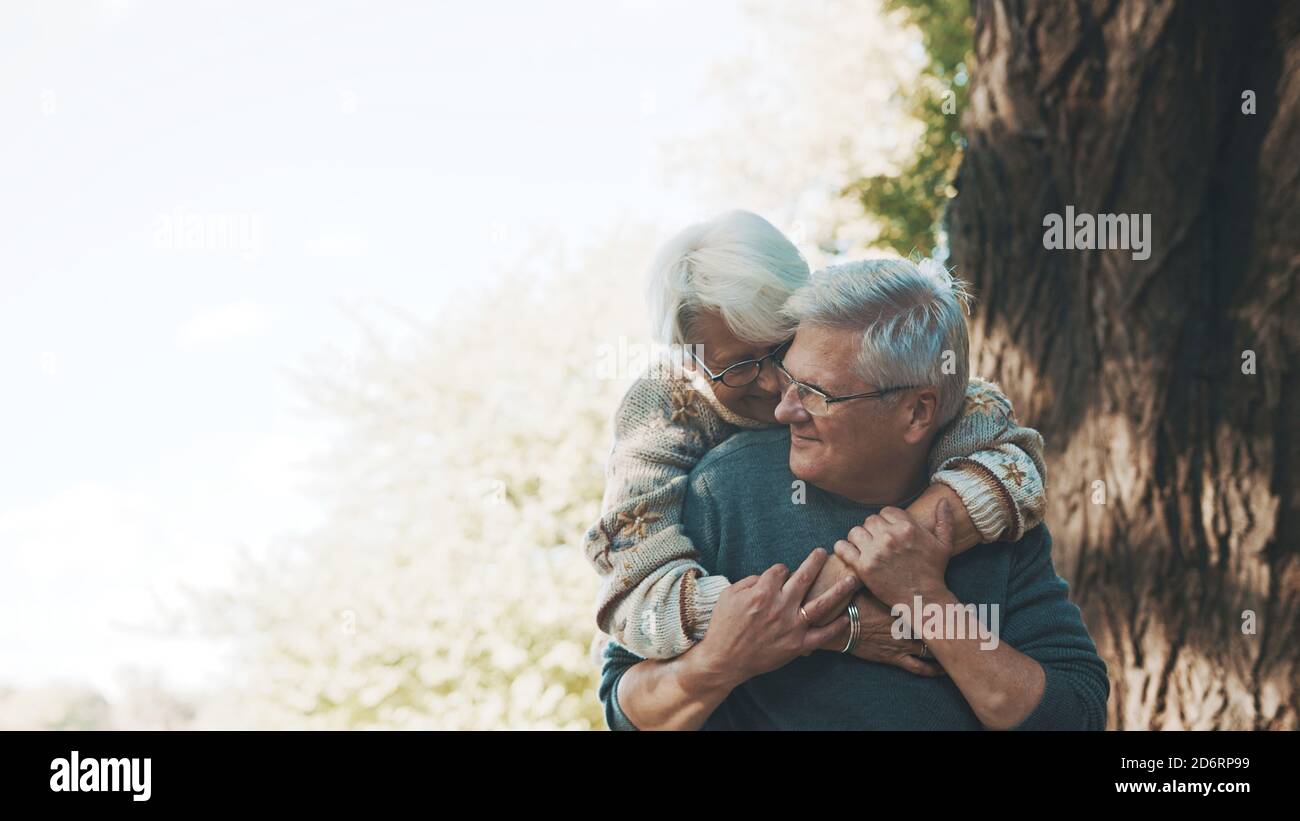 Happy old enjoying day in park. Senior man flirting with elderly woman. Dance in autumn day. High quality photo Stock Photo