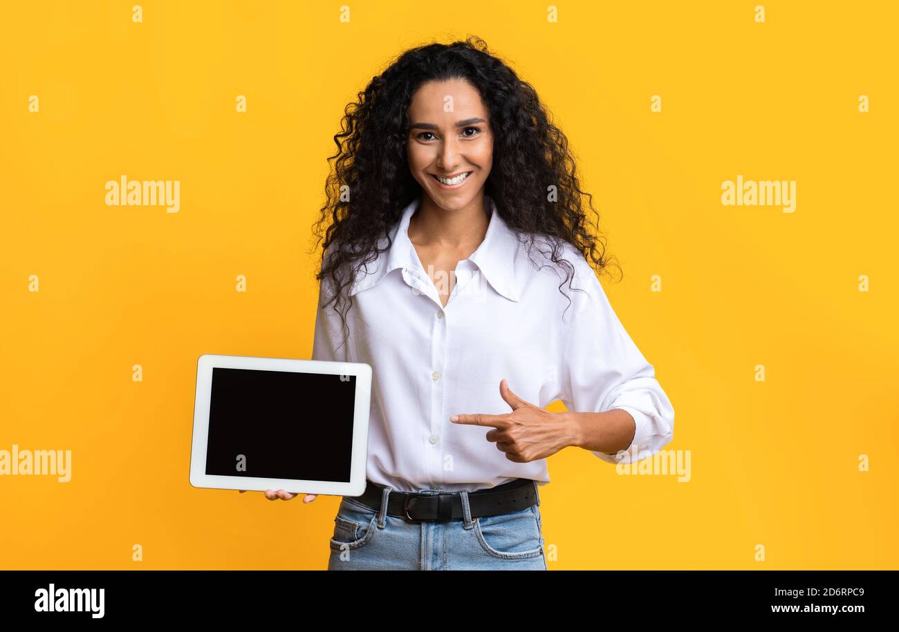 Check This. Positive Young Woman Pointing At Digital Tablet With Black ...