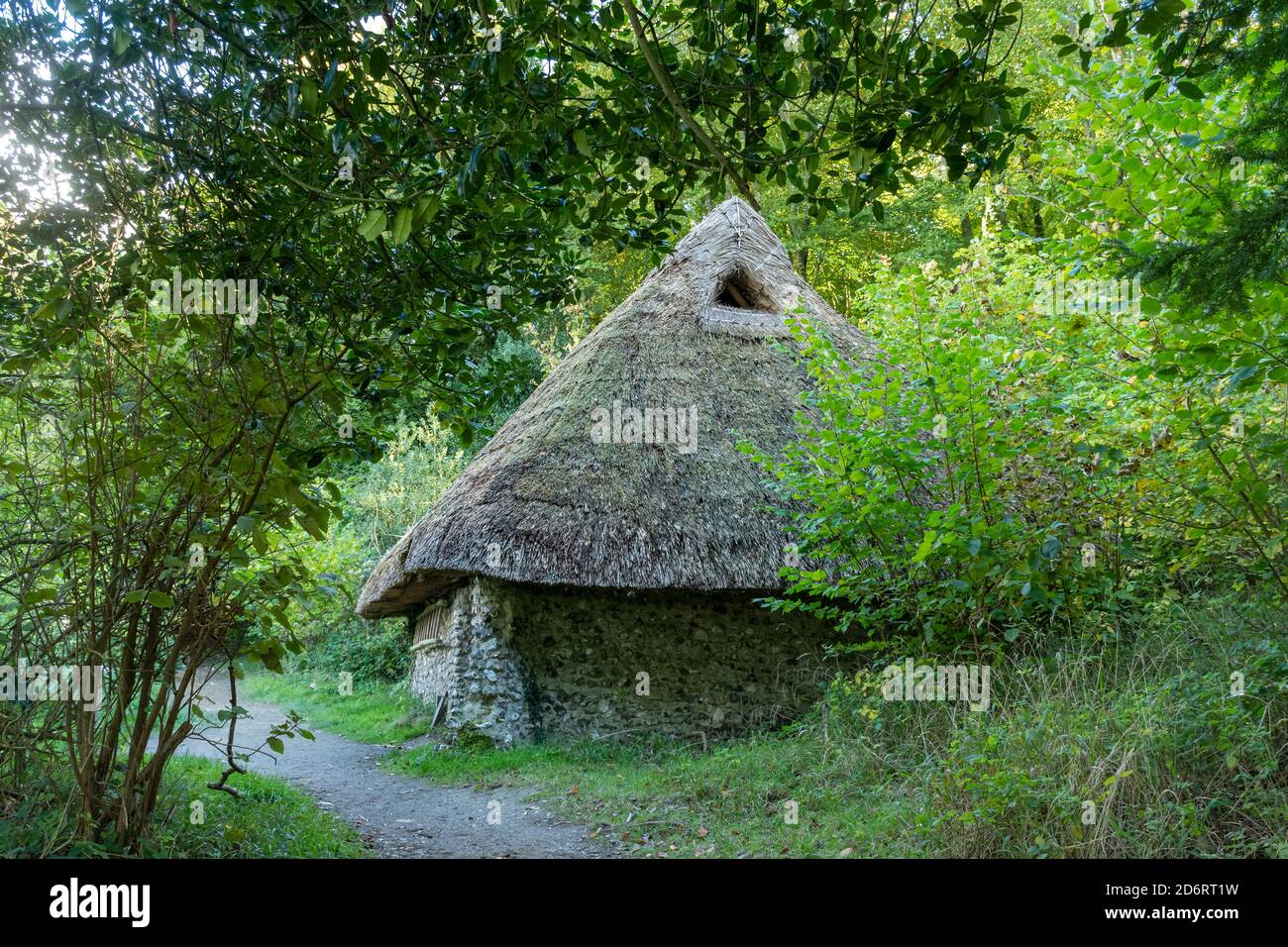 Weald and Downland Living Museum, an open air museum near Singleton, West Sussex, England, UK. Thatched medieval flint cottage with smoke holes. Stock Photo