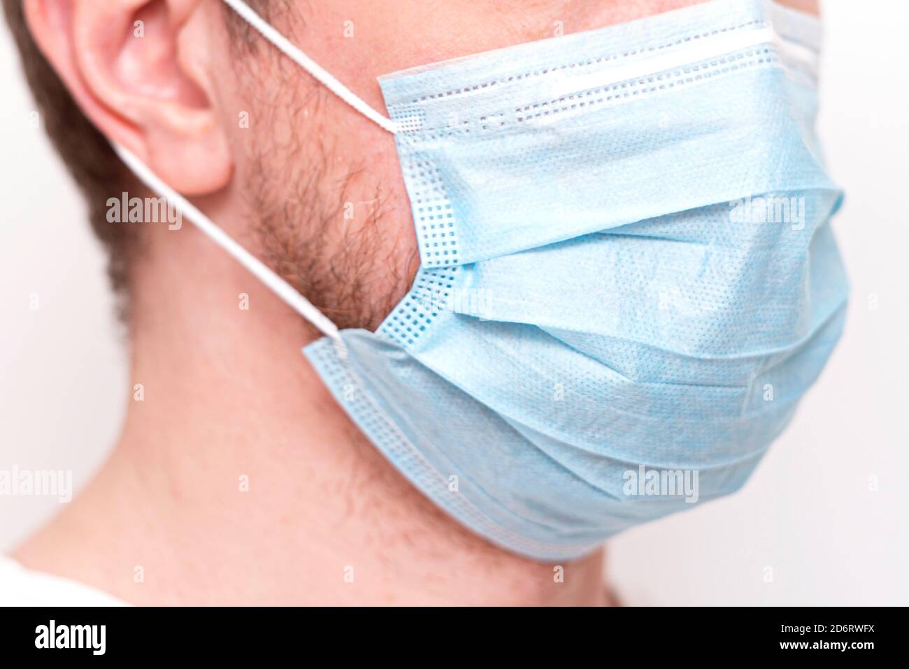 Close-up face of man with protective mask, medical mask on human face Stock Photo