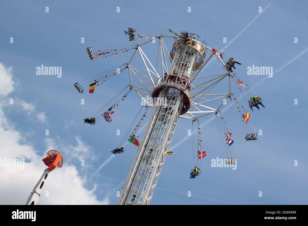 Yellow Vests invited to the fair of the throne in Paris : swing carousel for adults Stock Photo