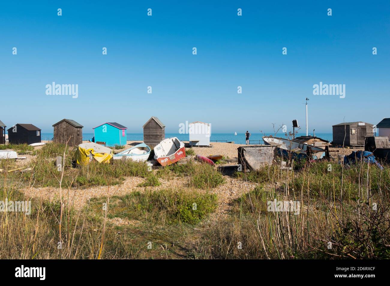 A row of beach huts across the wild flora along the beach at Kingsdown, Deal, Kent, UK Stock Photo
