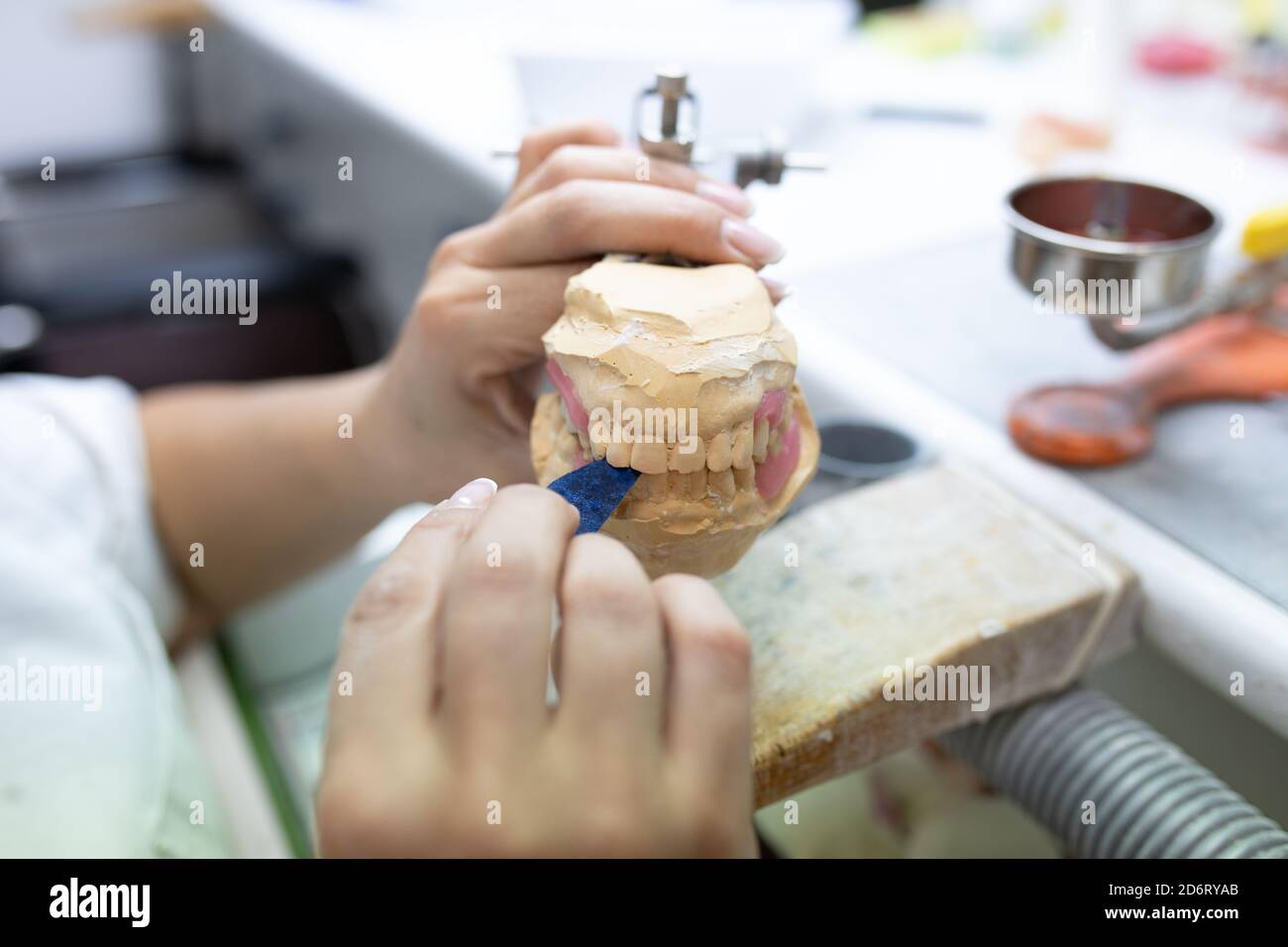 High angle side view of crop unrecognizable skilled dental technician