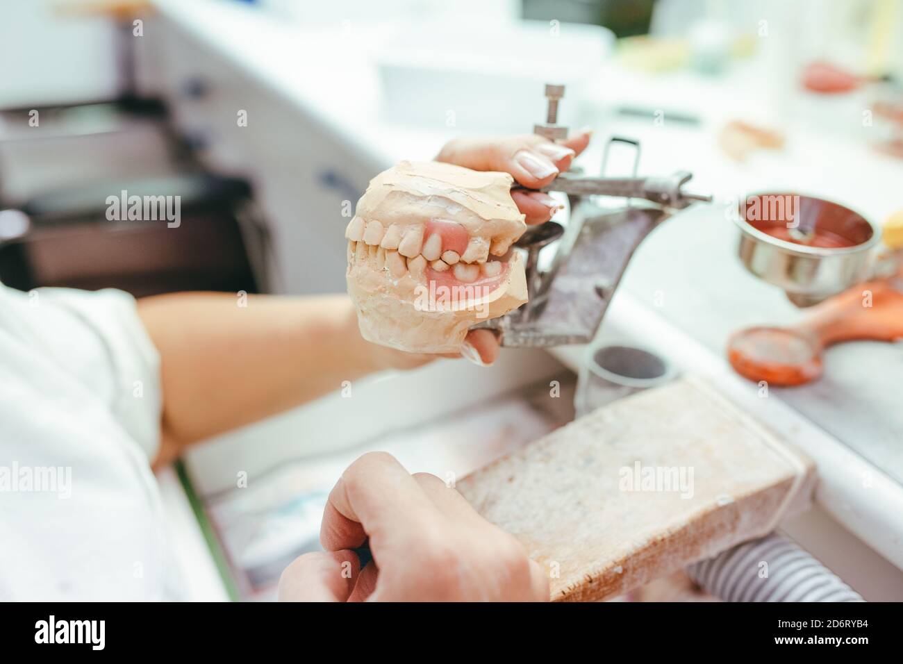 High angle side view of crop unrecognizable skilled dental technician