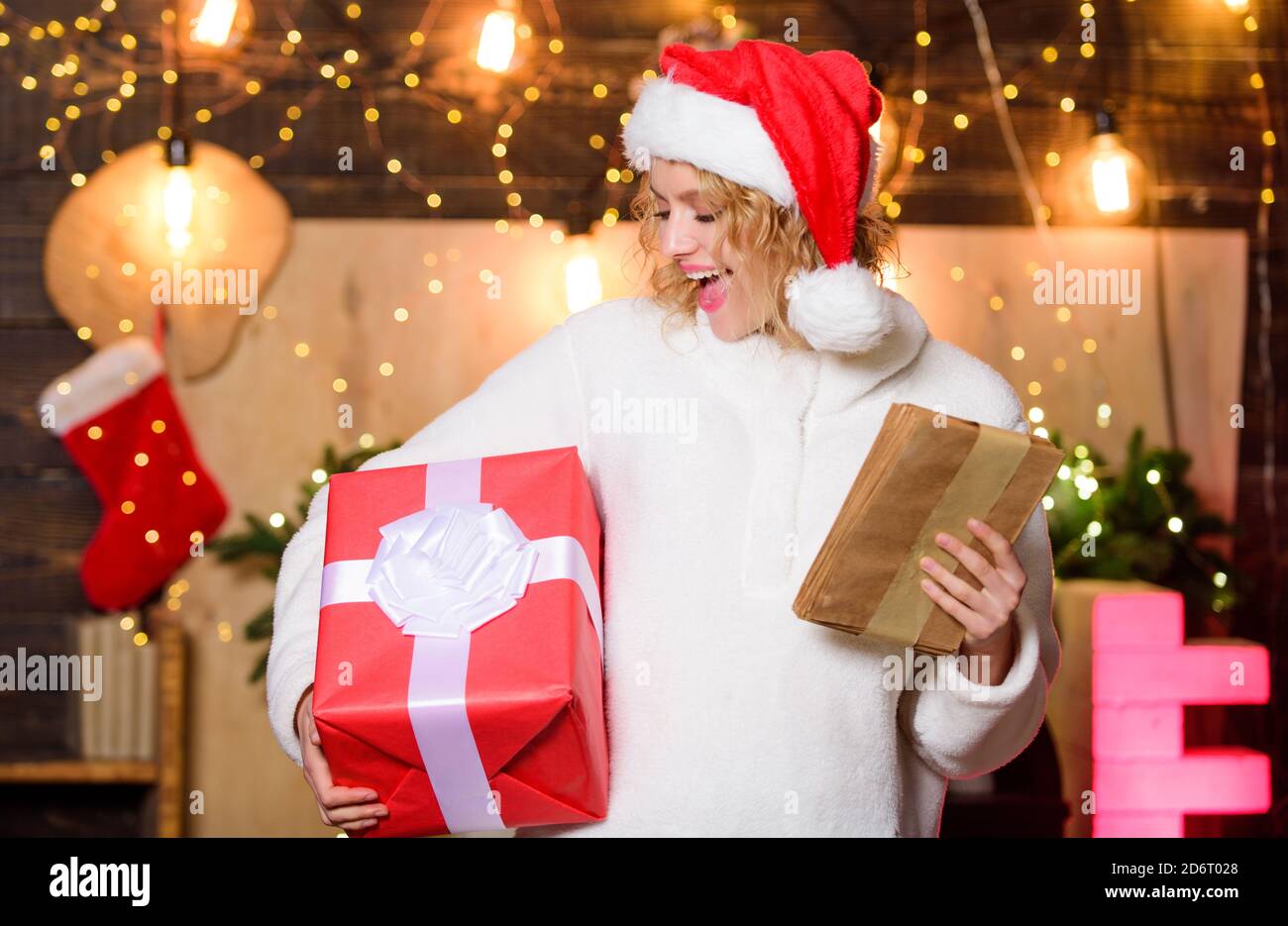 Girl Santa hat preparing checklist. To 